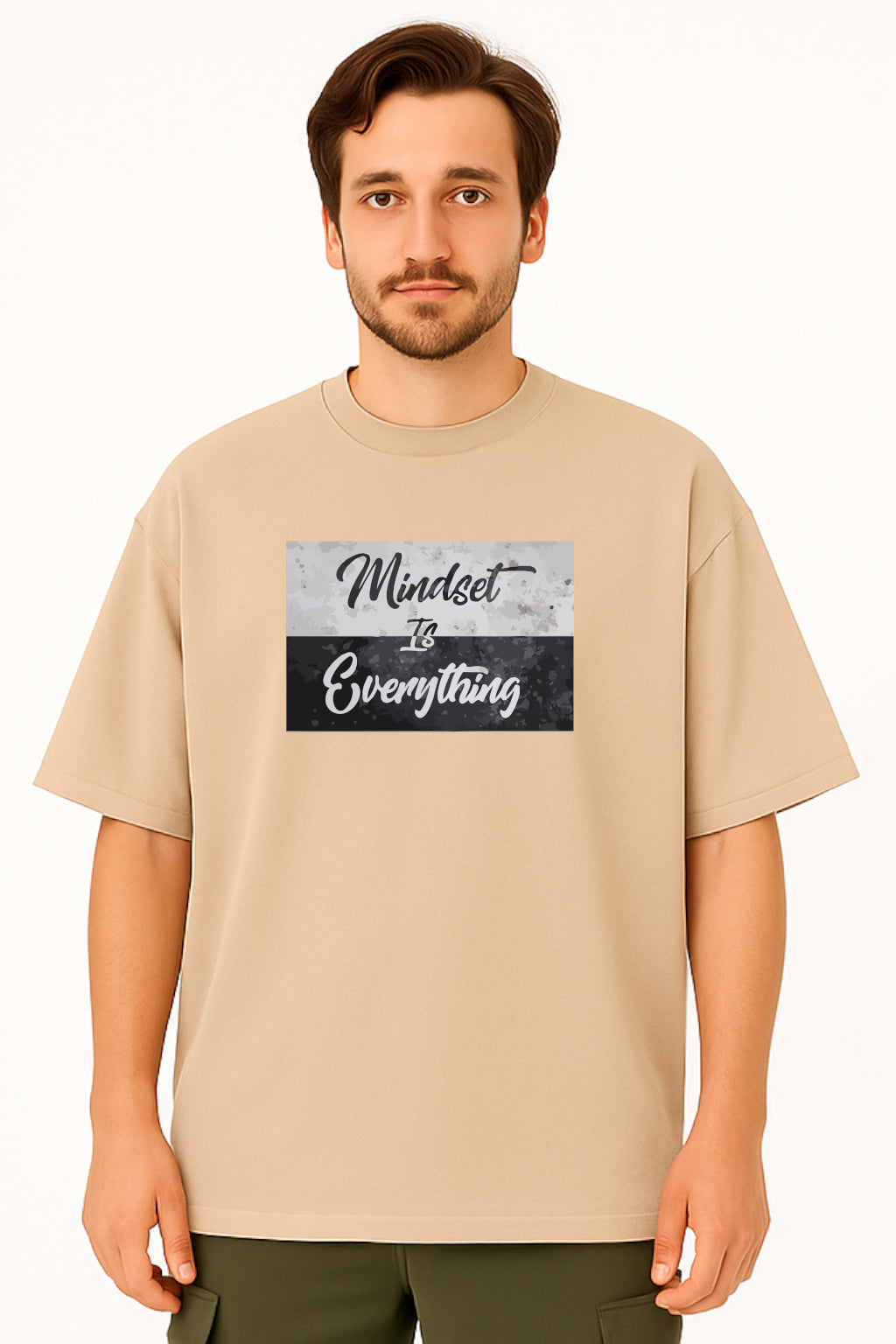 Man wearing a beige t-shirt with 'Mindset is Everything' text design on a white background