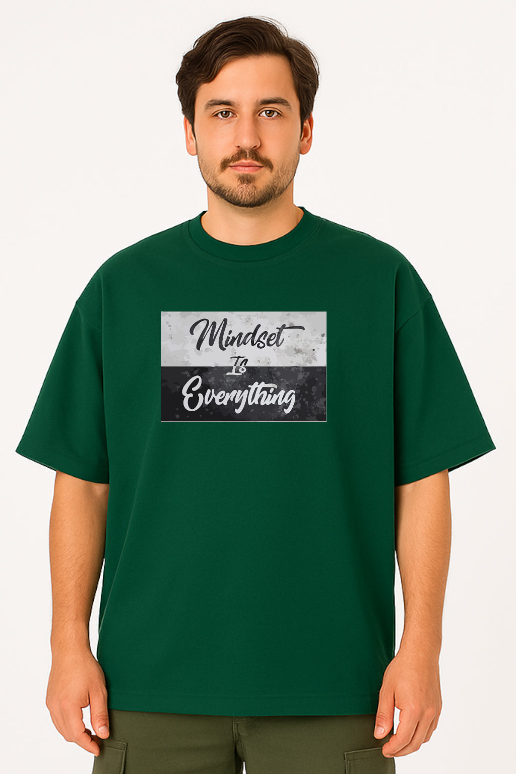 Man wearing a green t-shirt with 'Mindset is Everything' text design on a white background