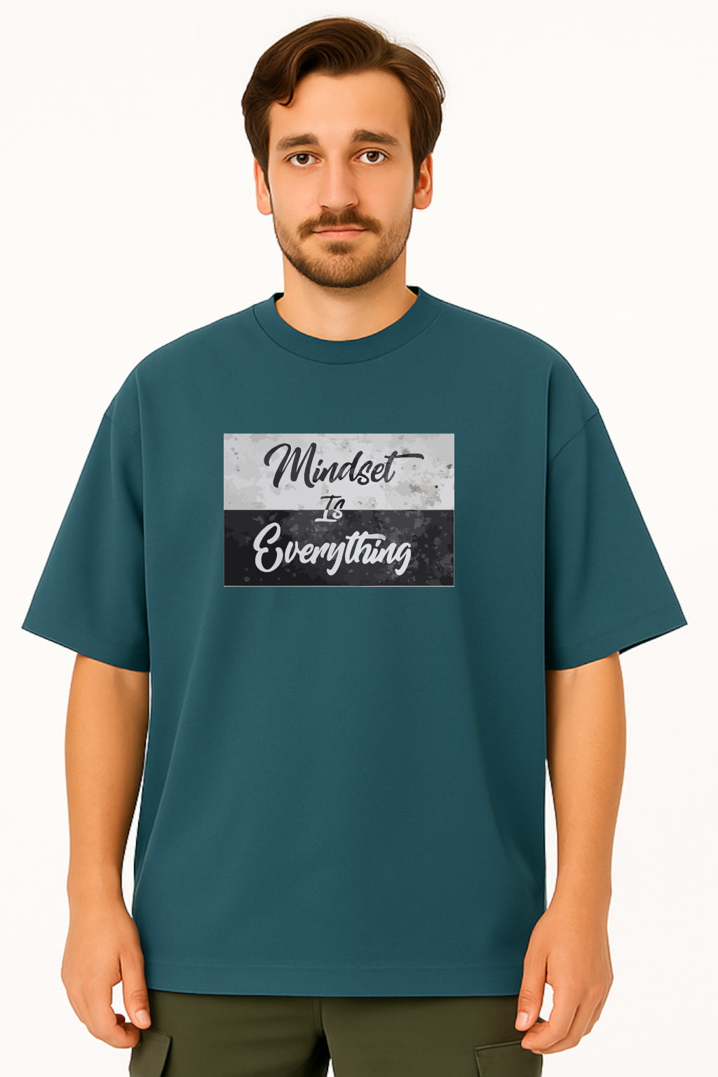 Man wearing a teal t-shirt with 'Mindset is Everything' text design on a white background