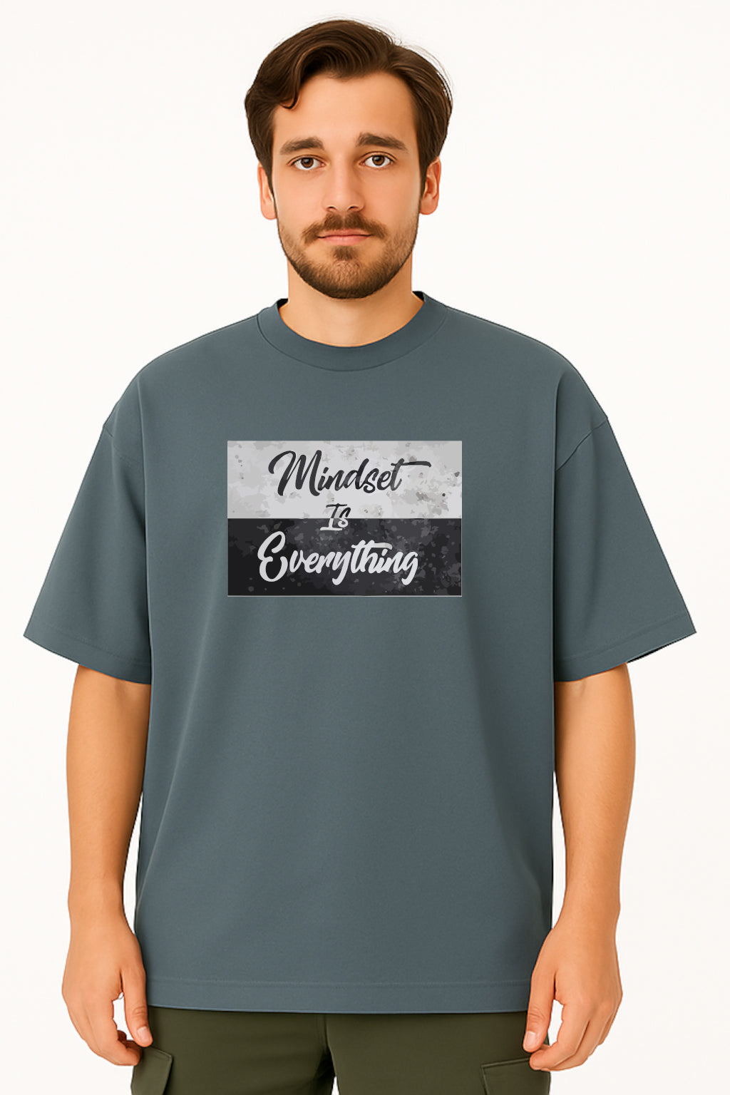 Man wearing a gray t-shirt with 'Mindset is Everything' text design on a white background