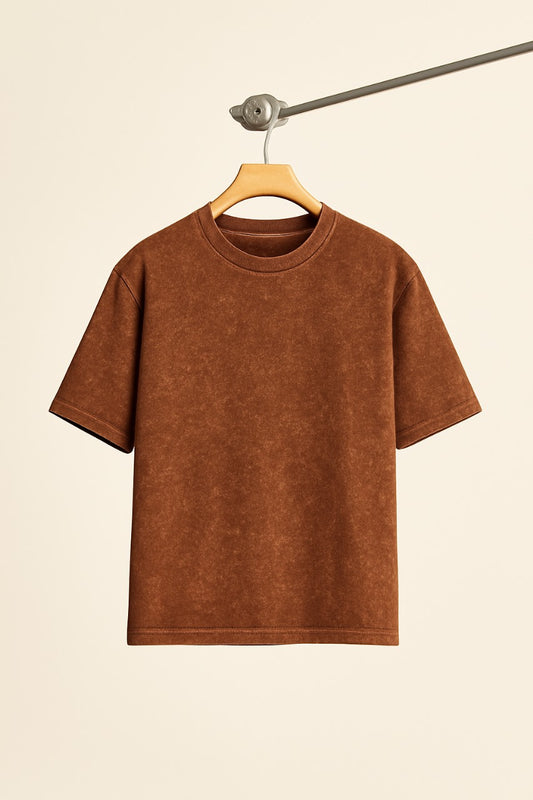 Brown t-shirt on a hanger against a beige background