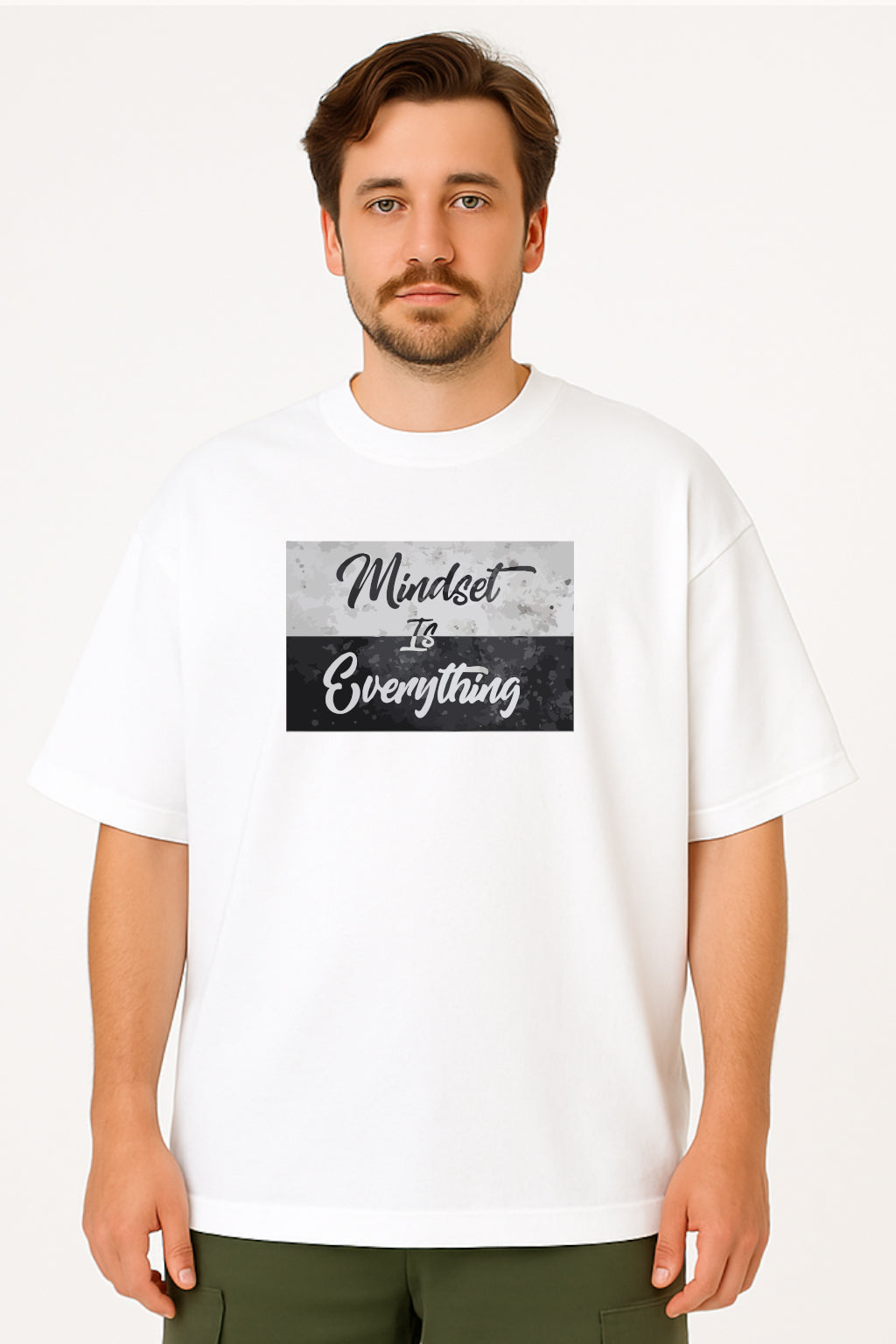 Man wearing a white t-shirt with 'Mindset is Everything' text design.