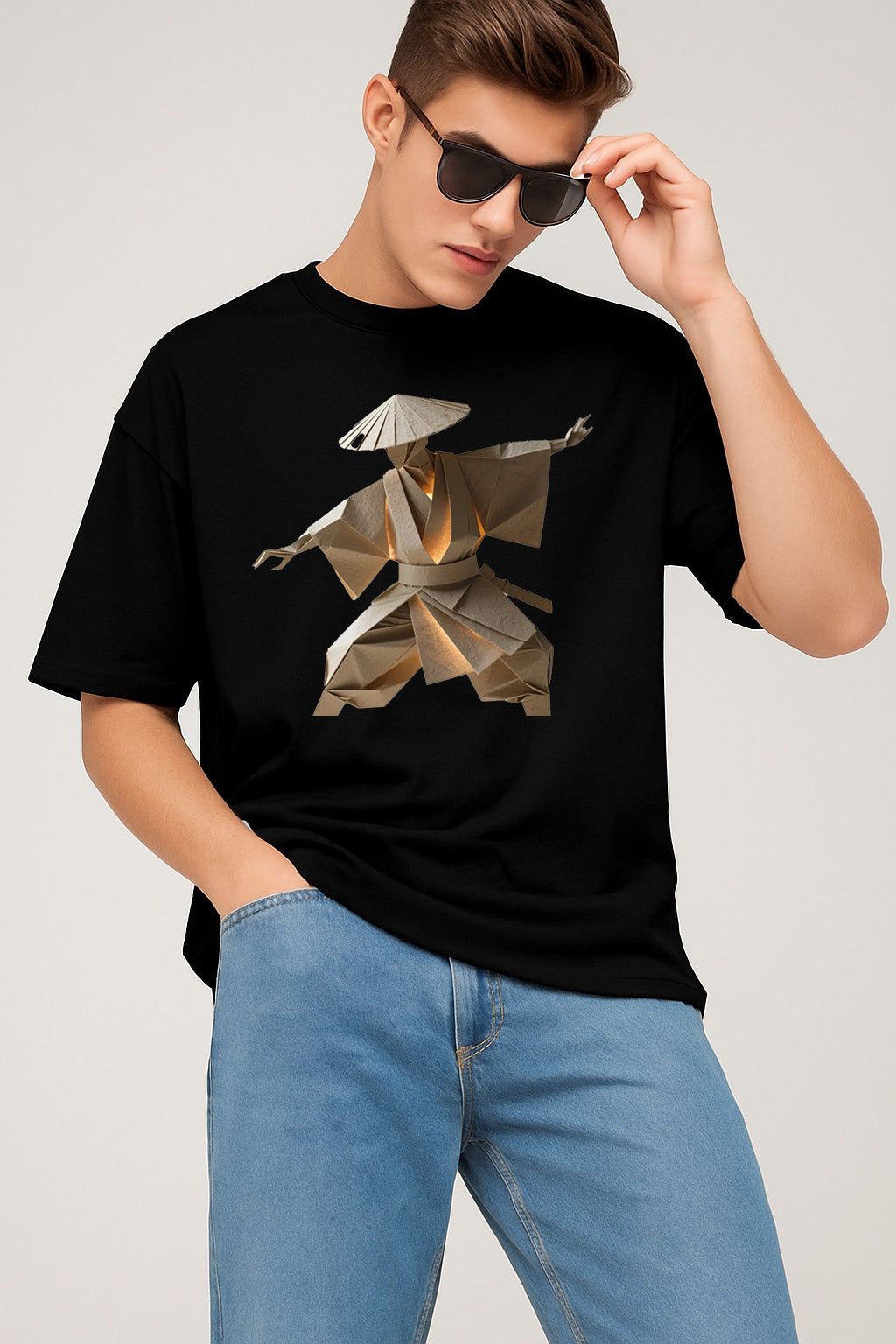 Person wearing a black t-shirt with a graphic design of a person in an umbrella and blue jeans on a light gray background.