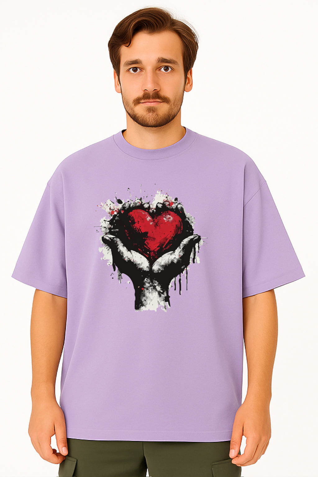 Man wearing a purple t-shirt with a graphic design of hands holding a heart.