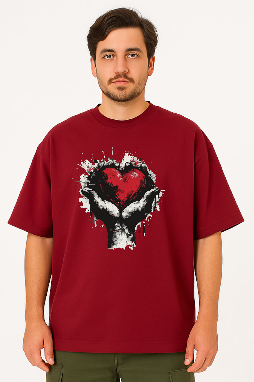 Man wearing a red t-shirt with a graphic design of a heart and hands on a white background