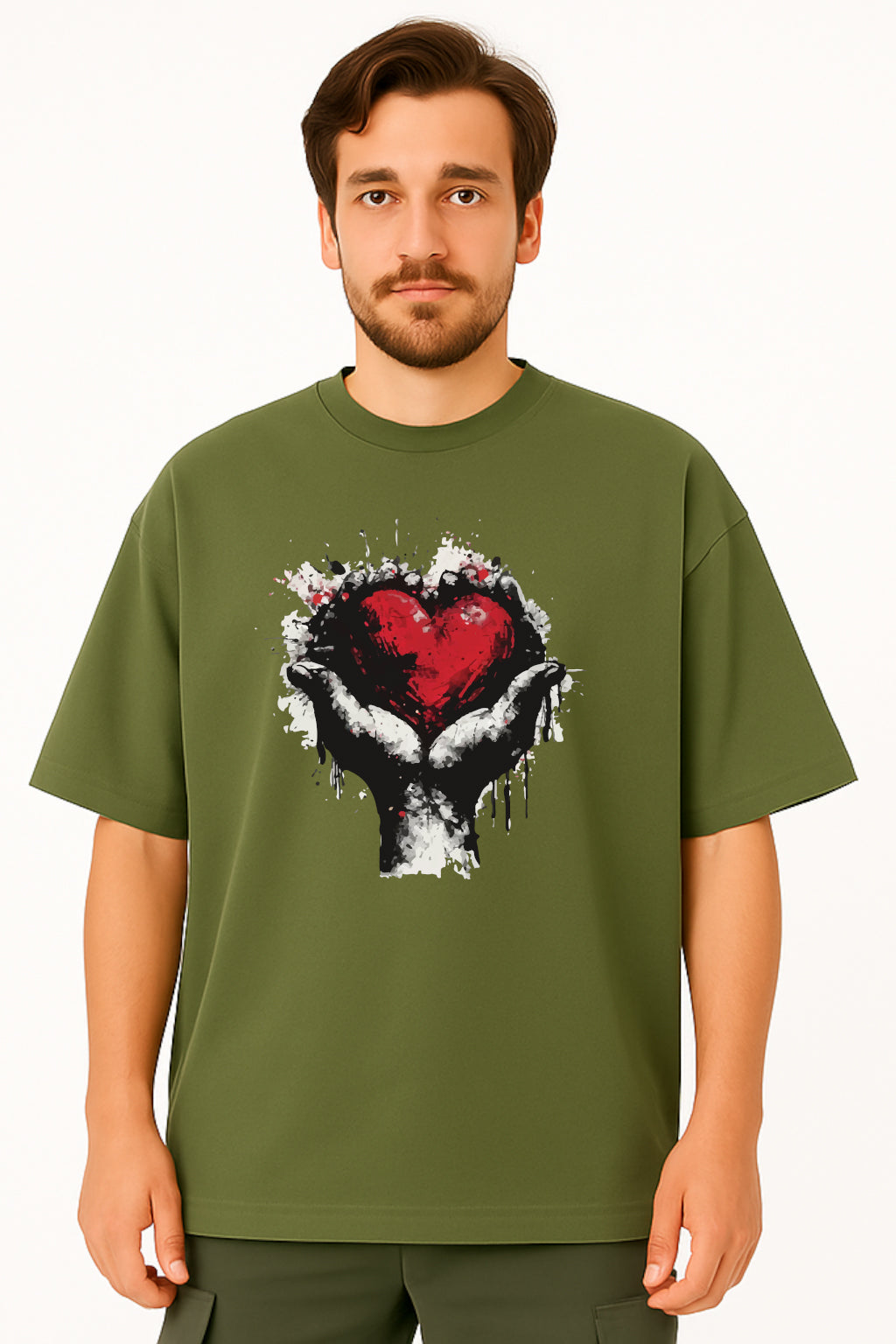 Man wearing a green t-shirt with a graphic design of a heart and hand holding a heart on a white background
