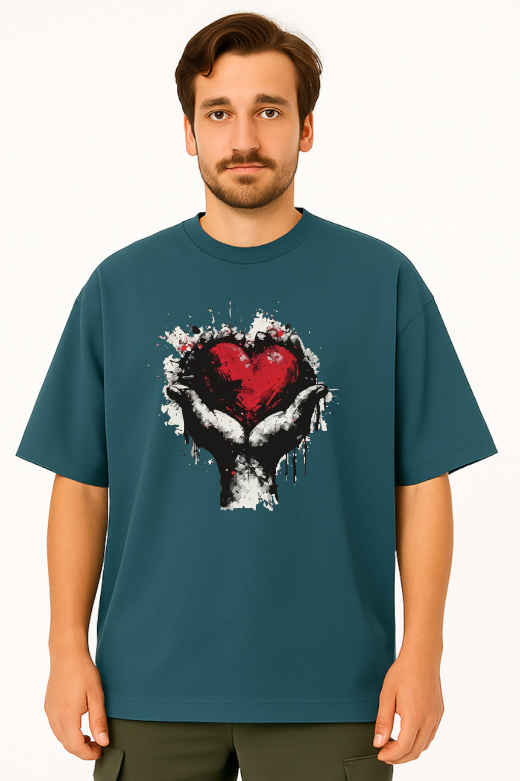Man wearing a teal t-shirt with a graphic design of a heart and hands on a white background
