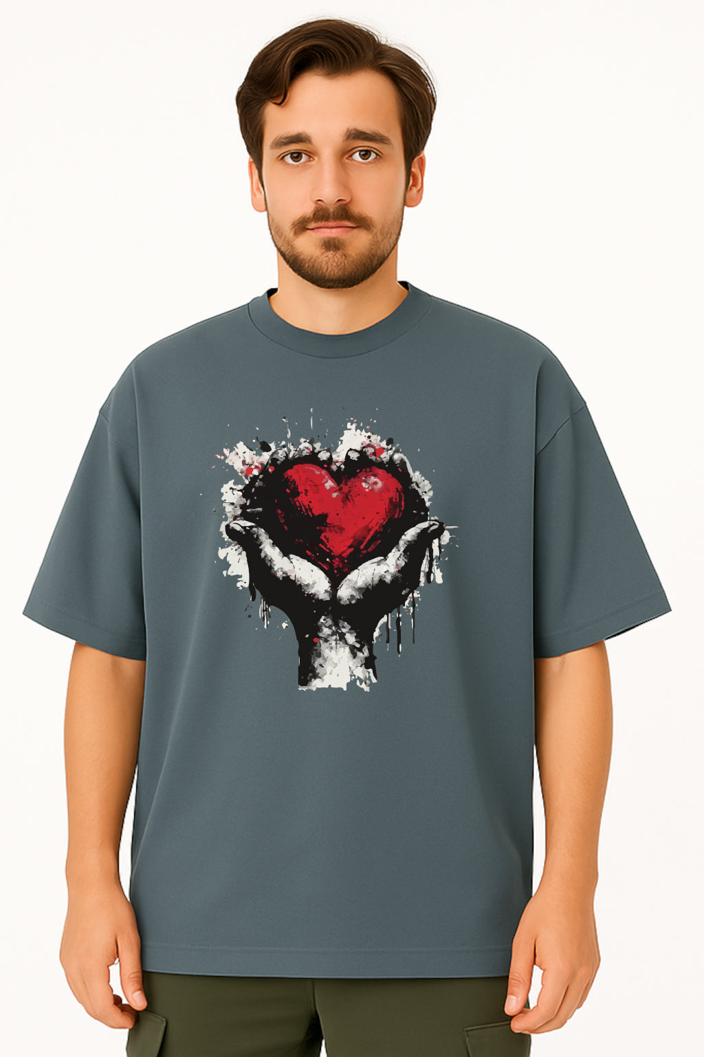 Man wearing a gray t-shirt with a graphic design of a heart and hands on a white background