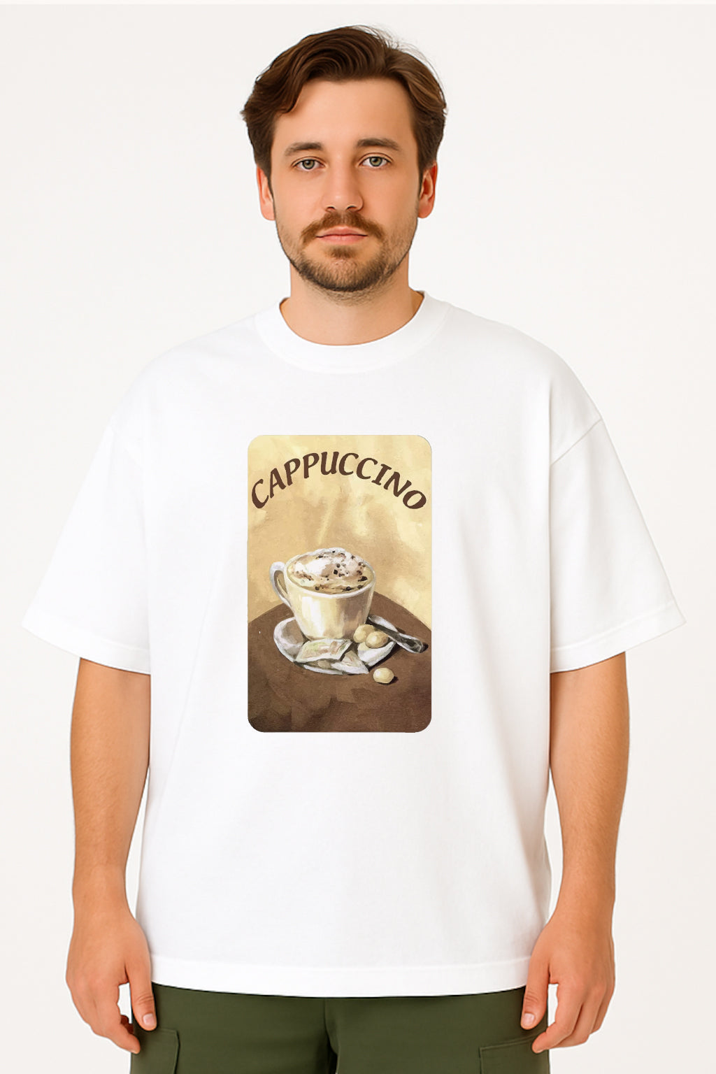 Man wearing a white t-shirt with a cappuccino graphic design on a plain background